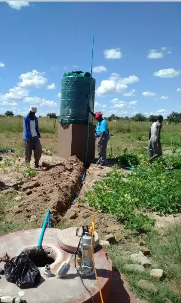 Submersible pump being lowered into a well